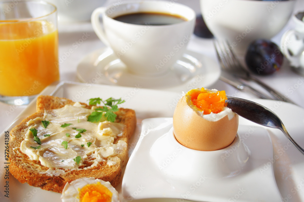 Fototapeta premium Brakfast table with soft boiled egg. Selective focus
