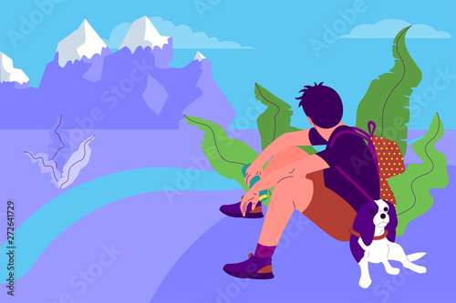 man with a dog is sitting and watching beautiful nature