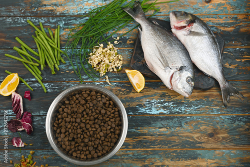 Canvas Print Special pet food and natural raw ingredients on rough dyed wooden background