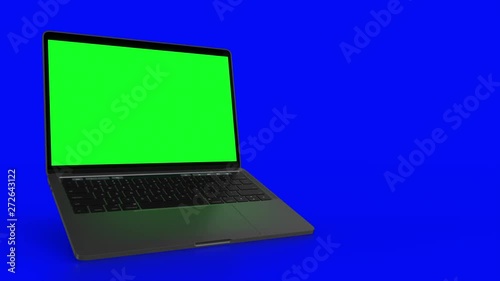4K Video. Laptop (Notebook) Turning On With green Screen On A blue Background. photo