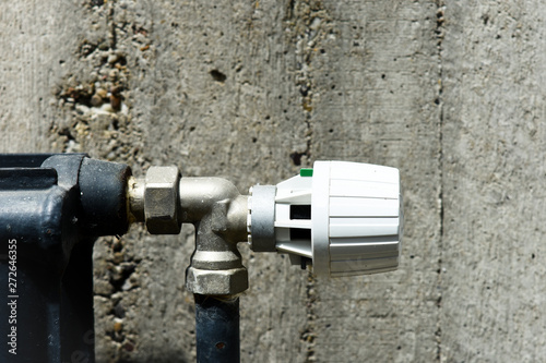 Heating thermostat on the concrete background
