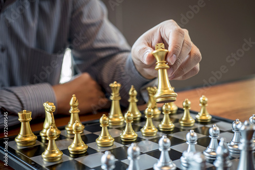 Gold and silver chess with player, Intelligent businessman playing chess game competition to planning business strategic to development for win and success