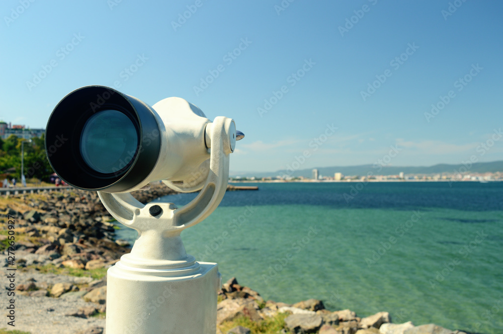 white telescope on the background of a beautiful sea landscape white telescope on the background of a beautiful sea landscape