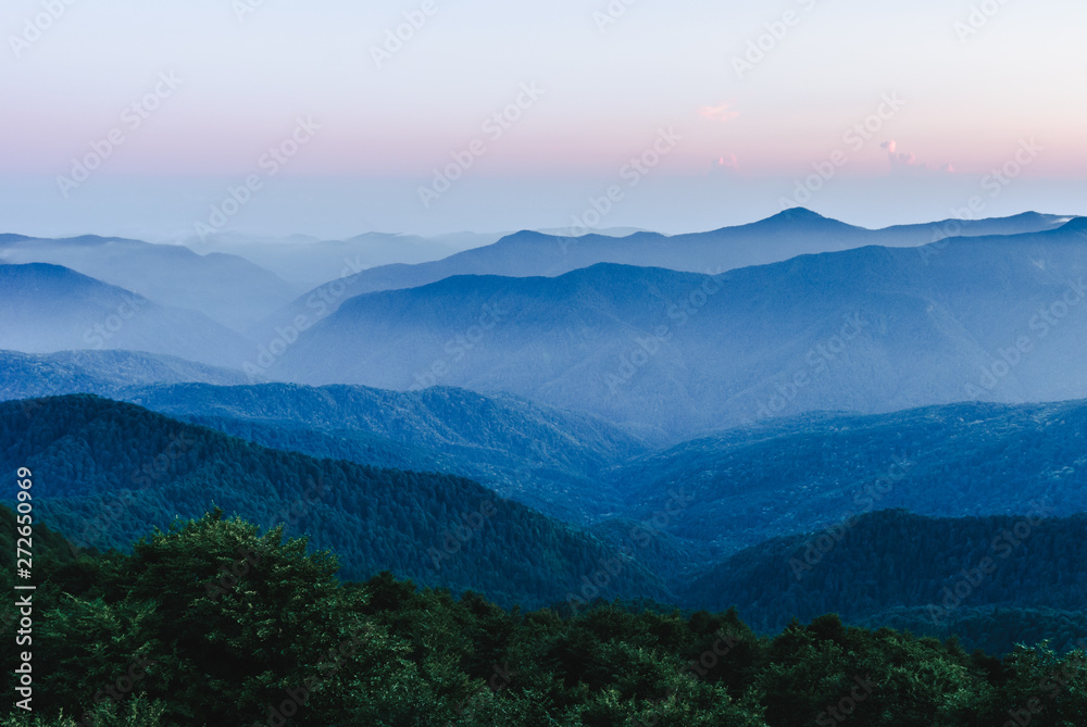Mountain ranges in the early morning at dawn. Fog haze