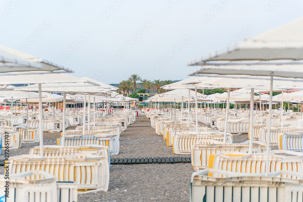 Fototapeta premium Placed in a rows lot of deck chairs on the beach at morning.