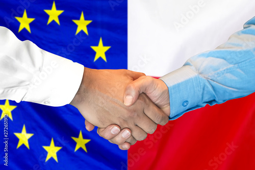 Business handshake on the background of two flags. Men handshake on the background of the European Union and Polish flag. Support concept