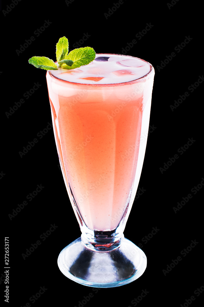 glass with fresh grapefruit summer alcohol cocktail, ice and mint on black isolated background
