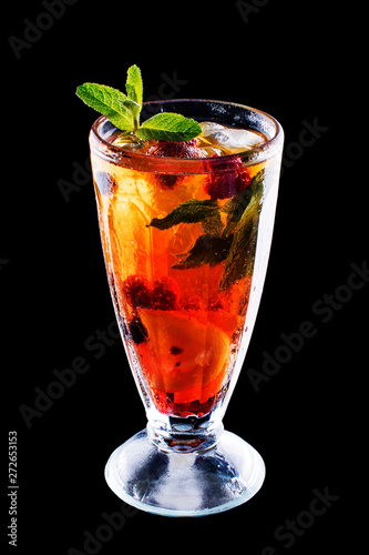 Fresh cold strawberry tea with ice and mint on black isolated background