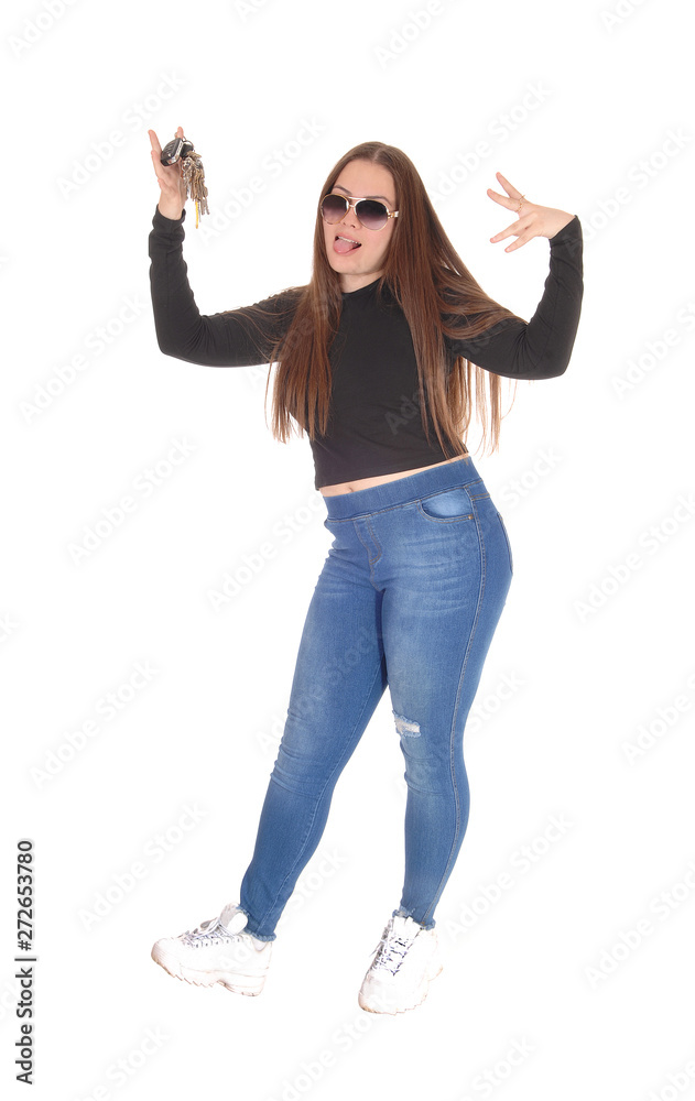 Happy young girl got a new car showing the keys
