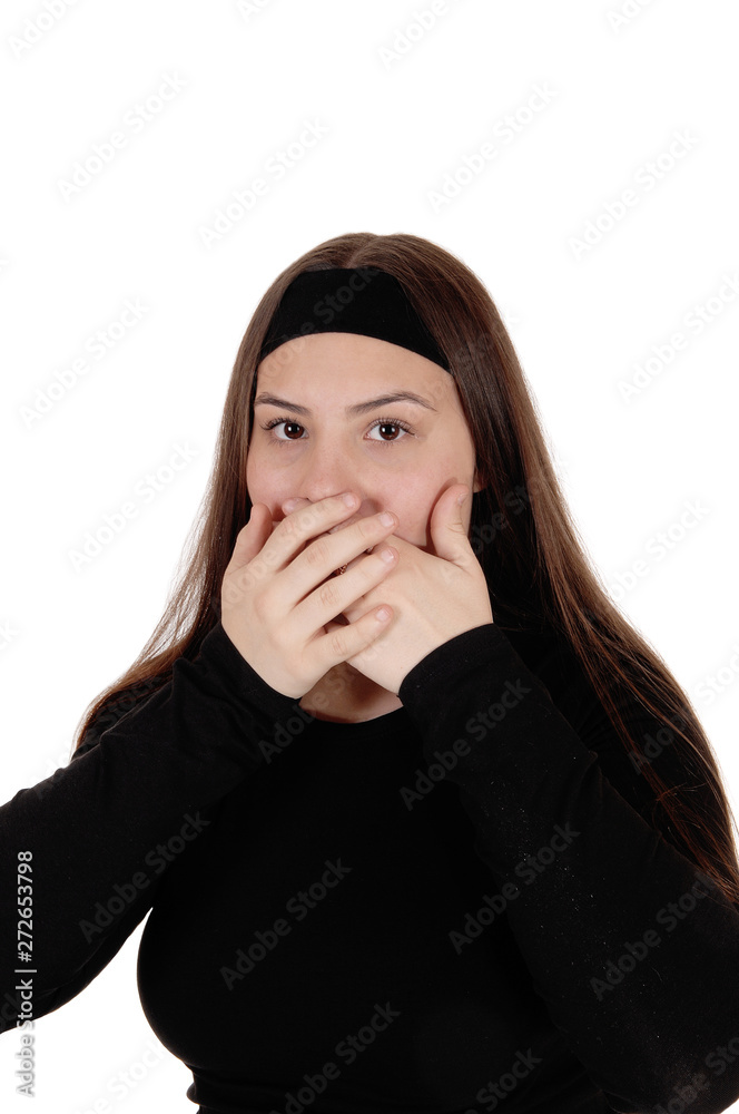 Surprised girl holding her hands over her mouths Surprised girl holding her hands over her mouths