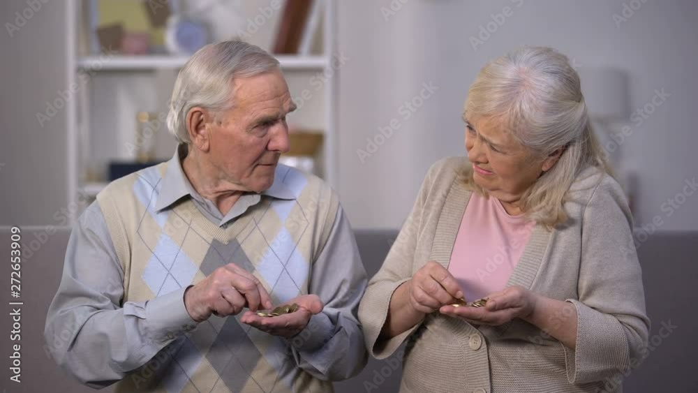 Sad aged couple counting coins, needing money for life, social insecurity Sad aged couple counting coins, needing money for life, social insecurity