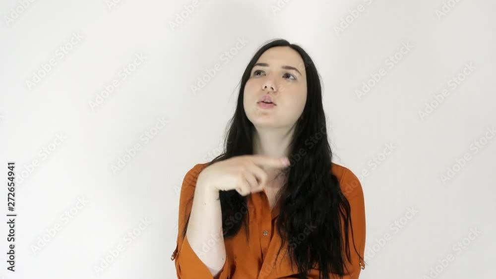 A woman looks up thoughtfully. Light background A woman looks up thoughtfully. Light background