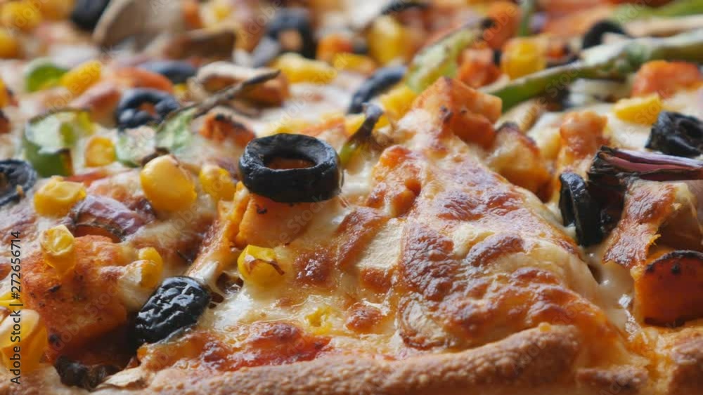 A close up view of pizza with vegetables.