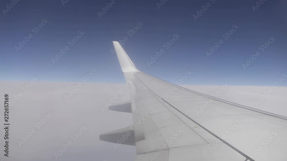 The most popular corner for traveling by plane is sitting by the window, watching the sky and white clouds The most popular corner for traveling by plane is sitting by the window, watching the sky and white clouds