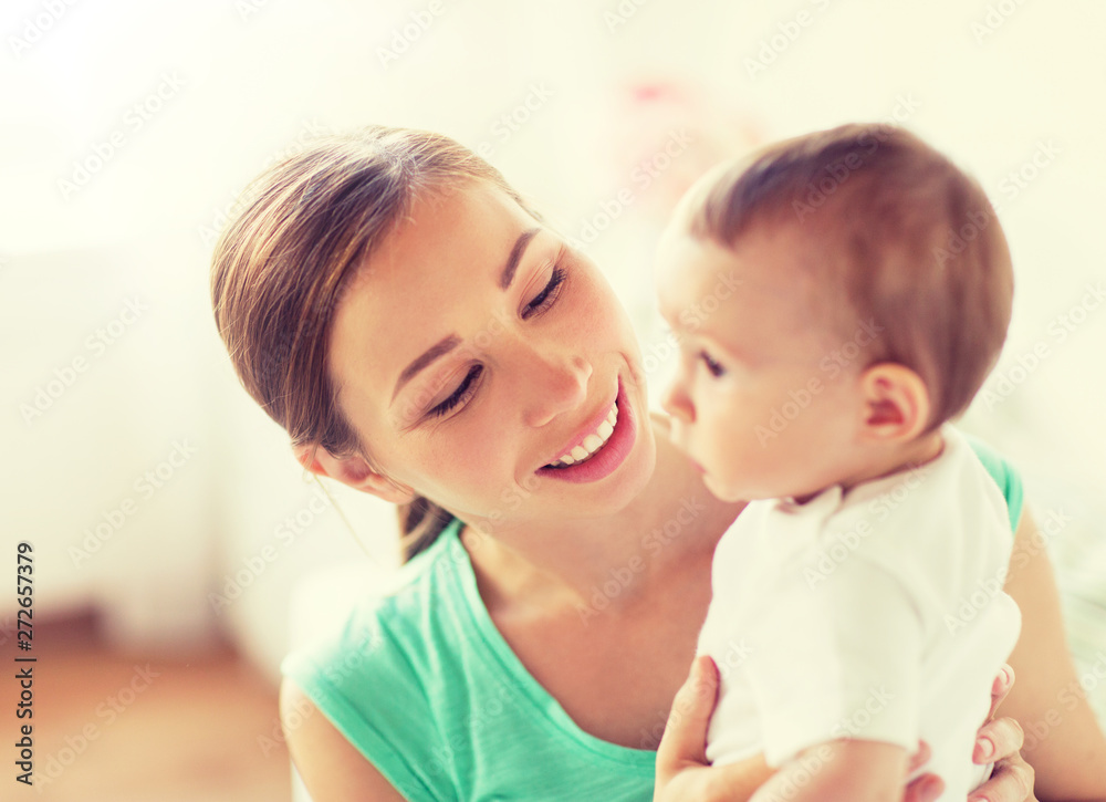 family, child and parenthood concept - happy smiling young mother with little baby at home family, child and parenthood concept - happy smiling young mother with little baby at home