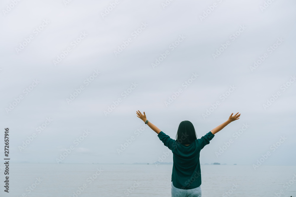 Woman rise hands up to sky freedom concept with blue sky. Woman rise hands up to sky freedom concept with blue sky.