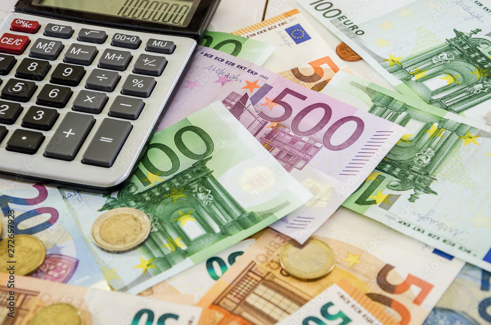 euro banknotes, coins and calculator on white table euro banknotes, coins and calculator on white table