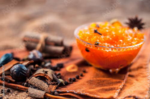 Famous Indian dessert and sweet dish in a glass bowl on jute bag's surface i.e. Murabba or Murba along with entire constituents of it on the surface.Made of Mango.Horizontal shot. photo