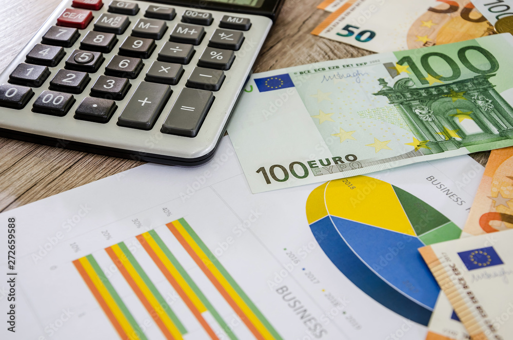 business charts, euros and a calculator on the table business charts, euros and a calculator on the table
