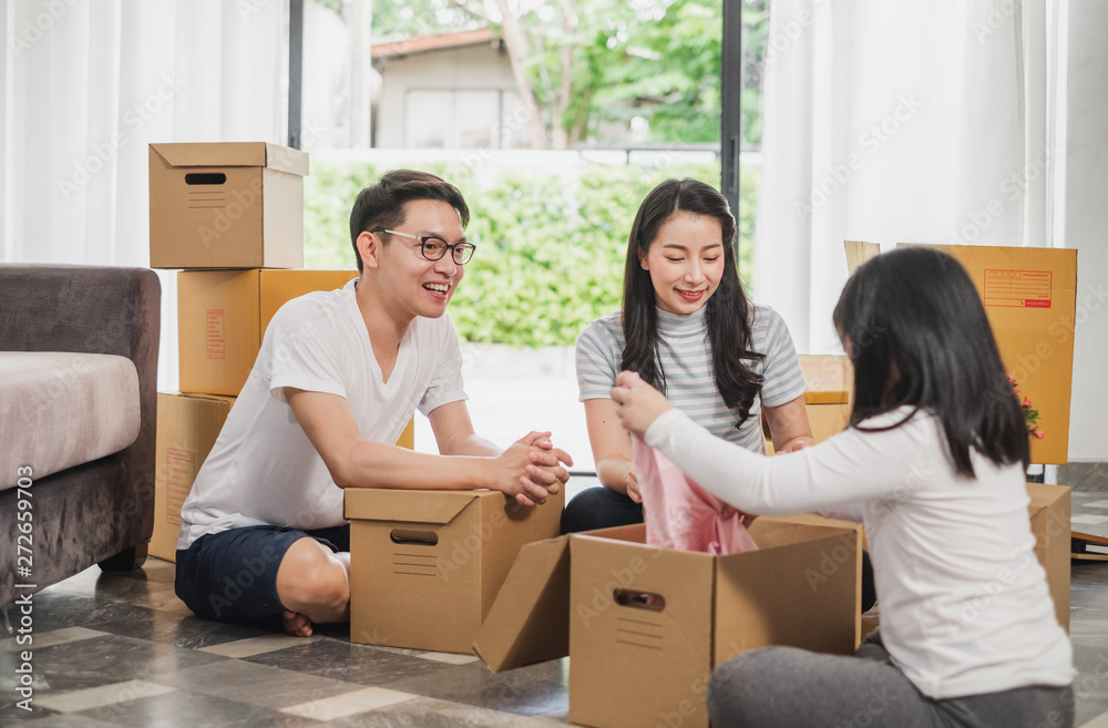 Asian family moving to new home/house and unpacking boxes Asian family moving to new home/house and unpacking boxes