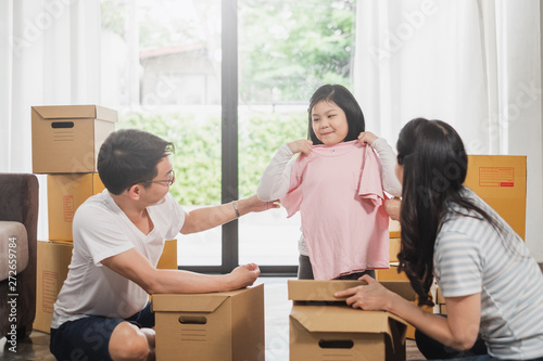 Asian family moving to new home/house and unpacking boxes © Nattakorn