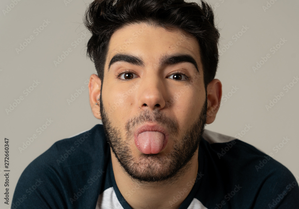 Fashion portrait of Attractive young manly man model posing happy and sexy for the camera Fashion portrait of Attractive young manly man model posing happy and sexy for the camera