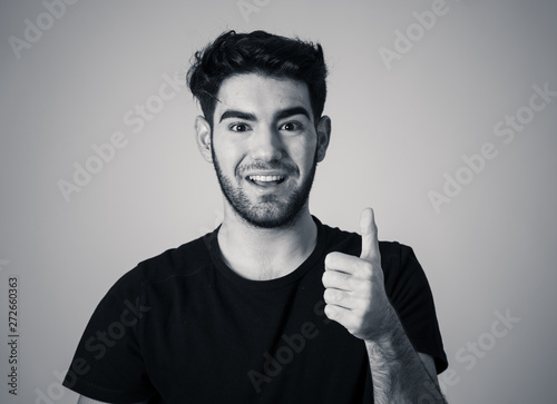 All great! Handsome man making thumbs up gestures feeling happy and successful