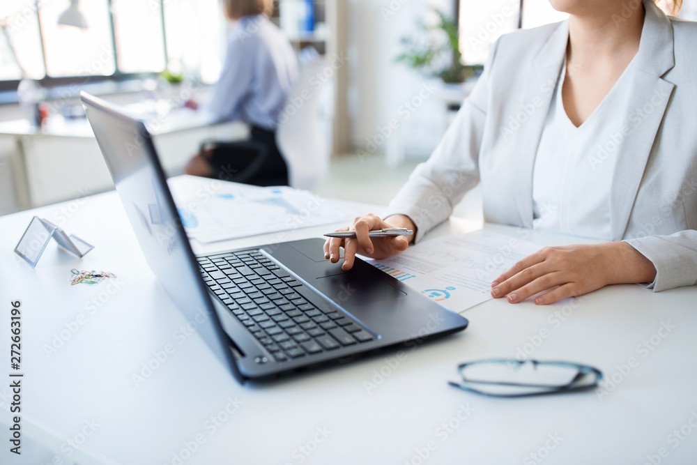 business and people concept - businesswoman with laptop computer and papers working at office business and people concept - businesswoman with laptop computer and papers working at office