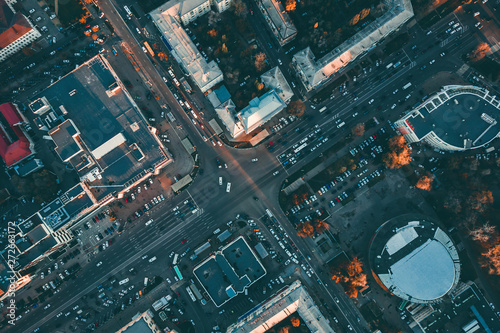Aerial top view of city asphalt roads with lot of vehicles or car traffic and buildings, modern urban intersections and junctions in midtown