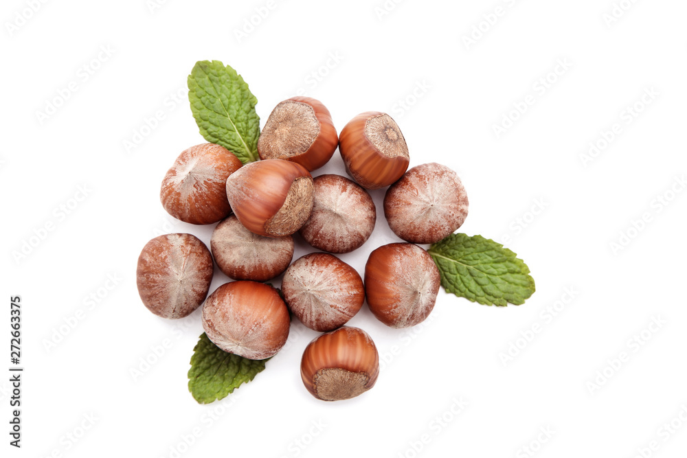 Hazelnuts with green leafs isolated on white background Hazelnuts with green leafs isolated on white background
