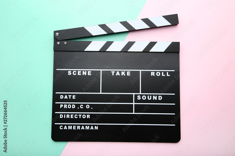 Clapper board on colorful background
