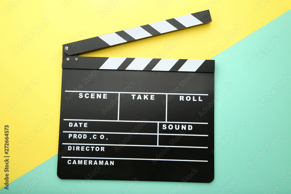 Clapper board on colorful background