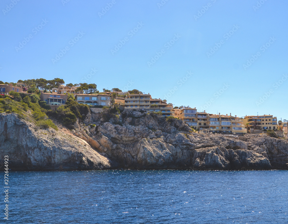 view of the coast with small houses in Palma de mallorca spain