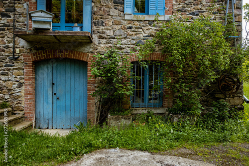 Old french farmhouse with blue windows and door