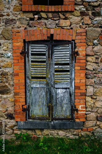 Broken shutters in derelict window