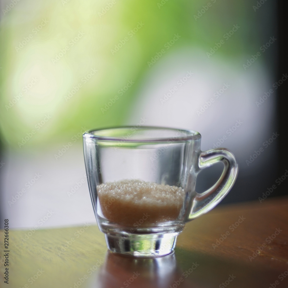 Sugar cane in glass on table with green background Sugar cane in glass on table with green background