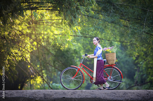 Photography Asian beautiful women wear traditional clothing with bicycles on cement bridges, women and bikes and rivers