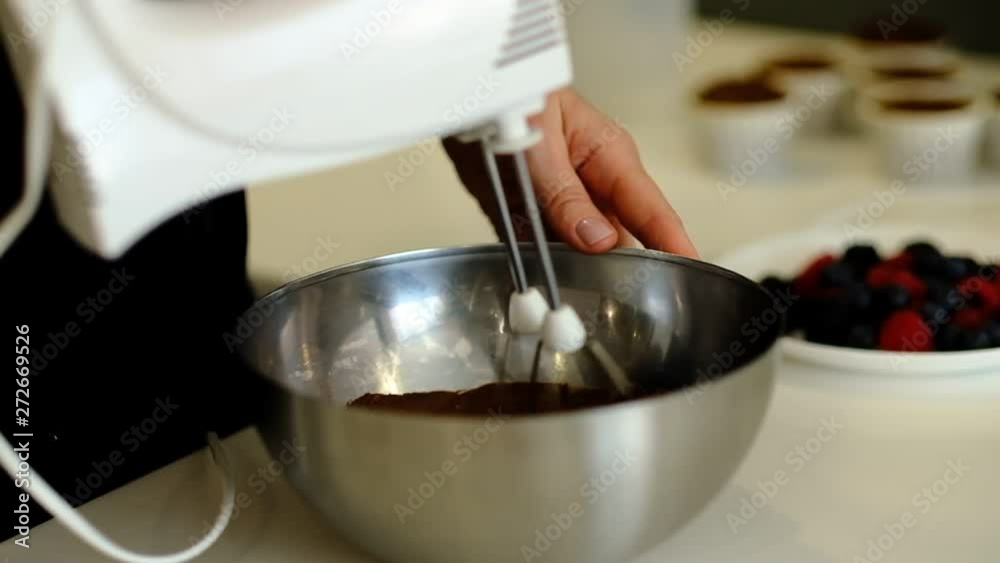 Whisks whipped chocolate cake dough in the bowl of glass. Whisk in glass bowl slow motion. Whisk for whipping. cook at home, make a cake, desserts, meringue Whisks whipped chocolate cake dough in the bowl of glass. Whisk in glass bowl slow motion. Whisk for whipping. cook at home, make a cake, desserts, meringue