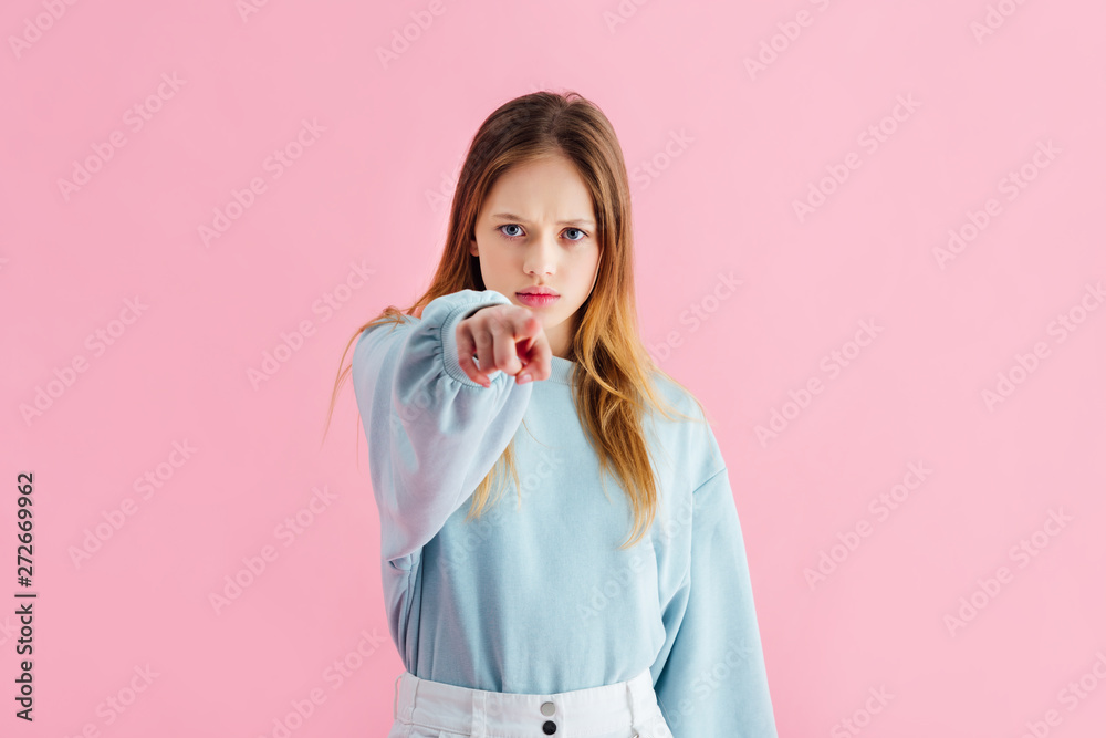 sad teenage girl pointing with finger at camera isolated on pink sad teenage girl pointing with finger at camera isolated on pink