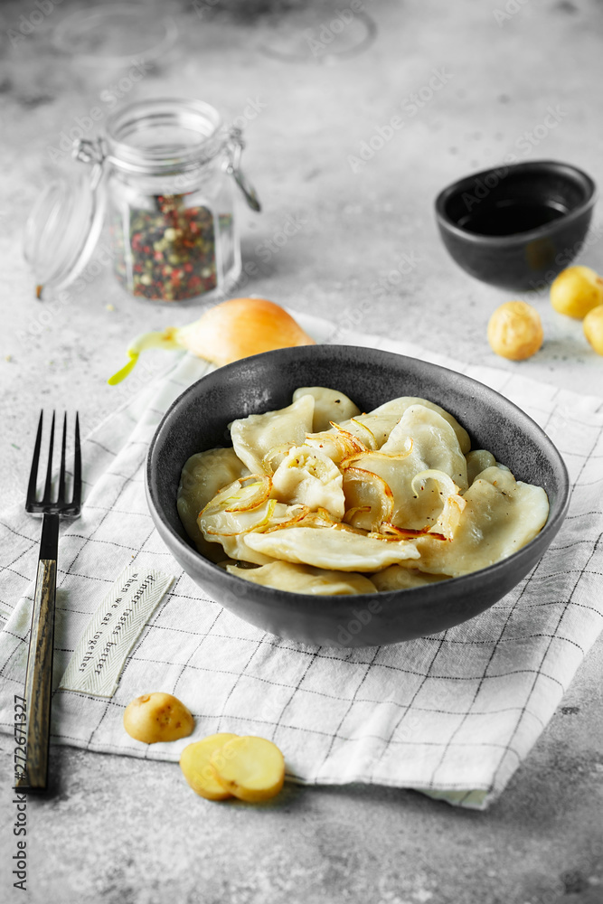 Dumplings, filled with mashed potatoes and onions. Russian, Ukrainian or Polish dish: varenyky, vareniki, pierogi, pyrohy. Food photo Dumplings, filled with mashed potatoes and onions. Russian, Ukrainian or Polish dish: varenyky, vareniki, pierogi, pyrohy. Food photo