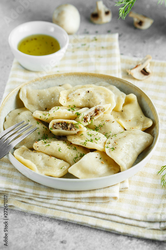 Dumplings, filled with mushrooms Champignon. Russian, Ukrainian or Polish dish: varenyky, vareniki, pierogi, pyrohy. Food photo