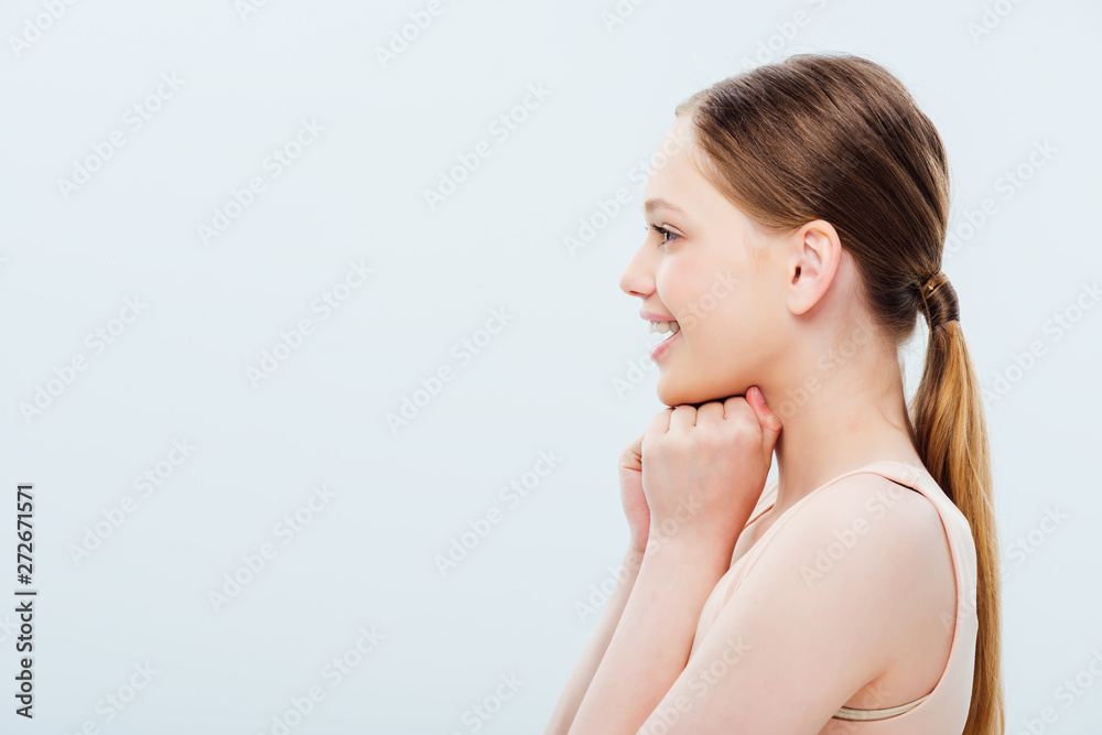 side view of happy teenage girl isolated on grey side view of happy teenage girl isolated on grey