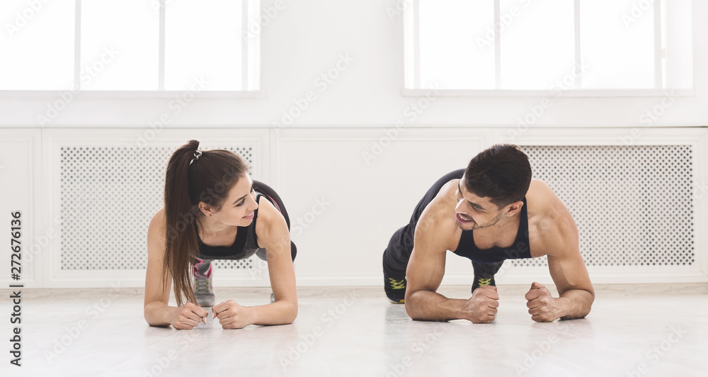 Successful couple standing in plank and looking at each other Successful couple standing in plank and looking at each other