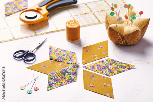 Design element of quilt in progress, prepared cut pieces and sew one around accessories