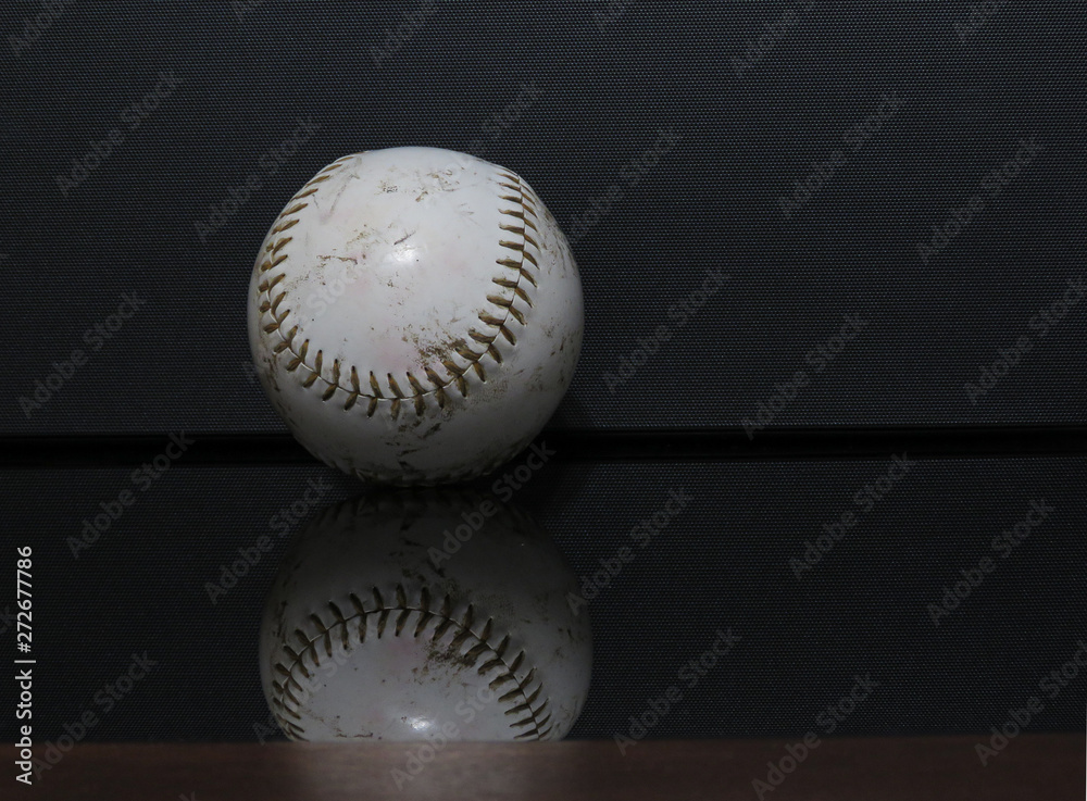 A horizontal photo of a baseball with a black background. A horizontal photo of a baseball with a black background.