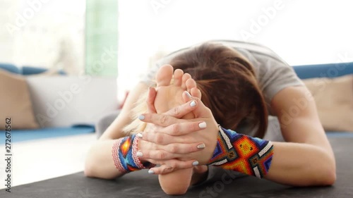 Young woman practicing yoga in yoga room on city background. photo