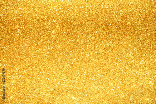 gold Sparkling Lights Festive background with texture. Abstract Christmas twinkled bright bokeh defocused and Falling stars. Winter Card or invitation
