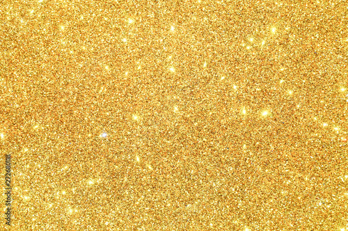 gold Sparkling Lights Festive background with texture. Abstract Christmas twinkled bright bokeh defocused and Falling stars. Winter Card or invitation