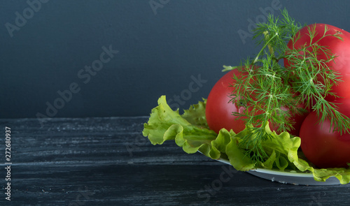 lettuce, tomatoes and dill on a white plate