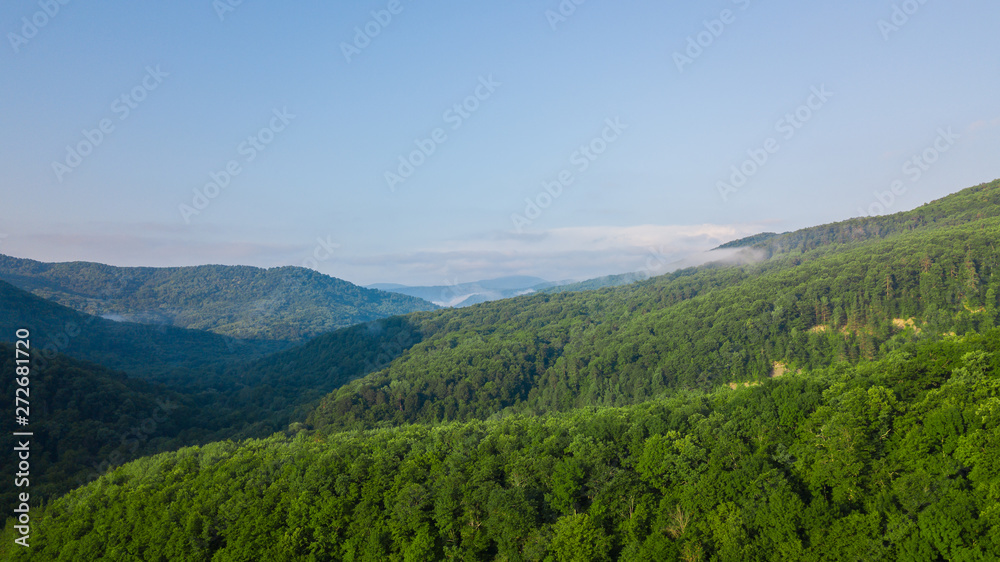 Aerial Landscape View of Caucasus mountain at sunny morning with fog.